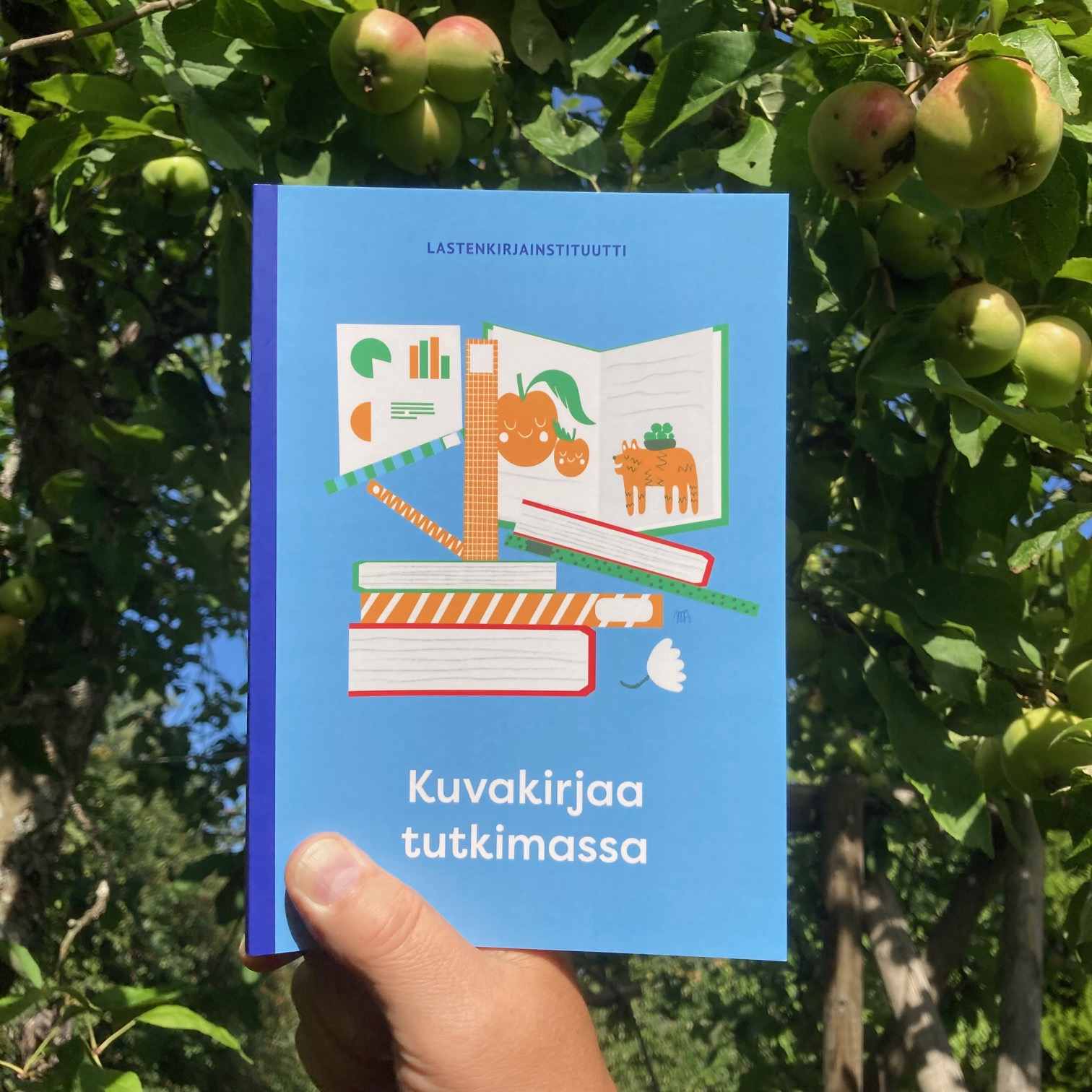 Kuvakirjaa tutkimassa -kirja vihreällä taustalla.